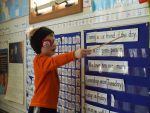 Child reads the friend of the day calendar.
